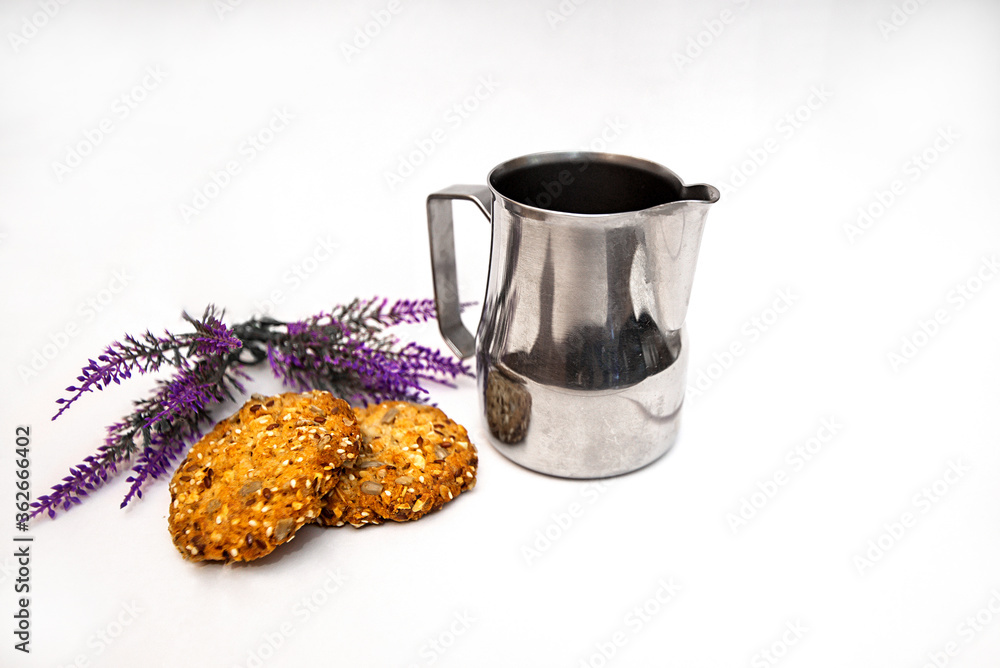 Pitcher milkman steel. lavender and spicy oatmeal cookies on a white background - obrazy, fototapety, plakaty 