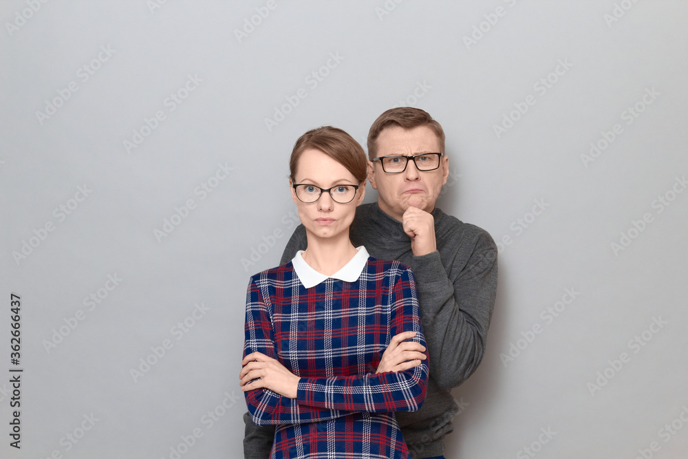 Funny weird couple, happy funny man and serious woman Funny weird couple, happy funny man and serious woman