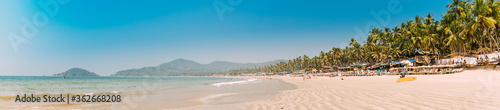 Canacona, Goa, India. Sunny Sky Over Calm Water Of Arabian Sea. Natural Landscape With Sandy Palolem Beach At Sunny Summer Day With Blue Sky photo