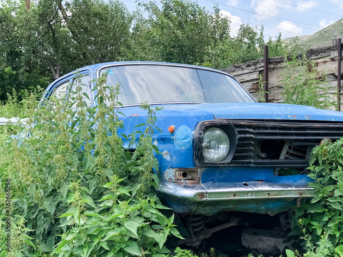 old abandoned car in the forest, old car in the forest