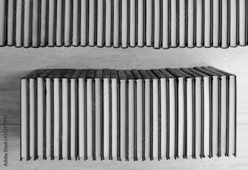 books in two rows  make elegant shape  black and white  wooden background  top view