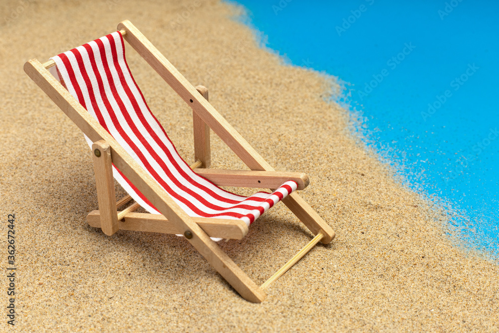 Beach chairs on pastel blue background. Summer vacation, travel. Miniature chair. Beach chairs on pastel blue background. Summer vacation, travel. Miniature chair.