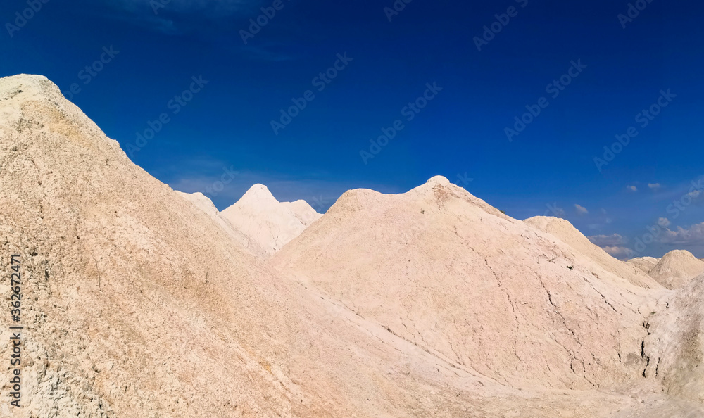 Sandy high hills against the blue sky. Beautiful panoramic view. Wallpaper, screen saver, cover.