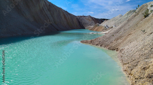 Beautiful summer landscape. Turquoise water between sand mountains in the desert.