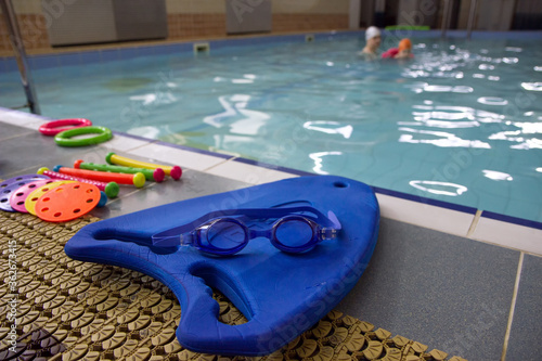 Blue swimming boards with swimming glasses and toys of the pool photo