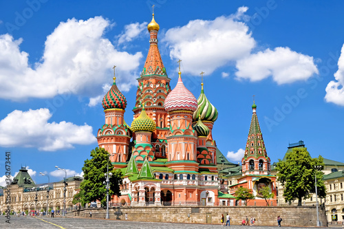 famous moscow city russia landmark saint basil's cathedral on red square next to kremlin on summer against blue sky with clouds background. Street wide view of russian nation historic heritage