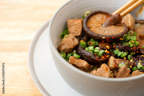 Top view of Slow cooked pork spare noodles with shiitake Mushroom and mixed vegetables or Braised pork noodle soup, Thai, Chinese and Taiwanese cuisine