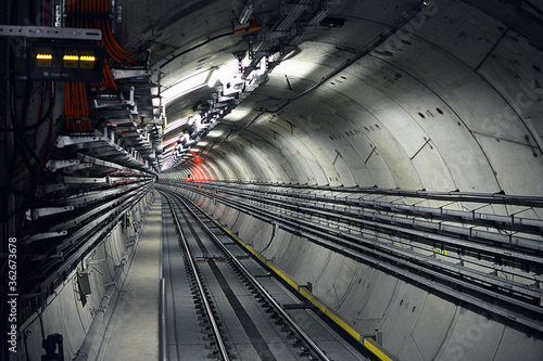 Metro tunnel (subway or underground) with precast concrete linings (segments or rings) with a red light (red signal)