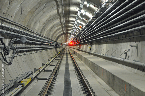 Metro tunnel (subway or underground) with precast concrete linings (segments or rings) with a red light (red signal)