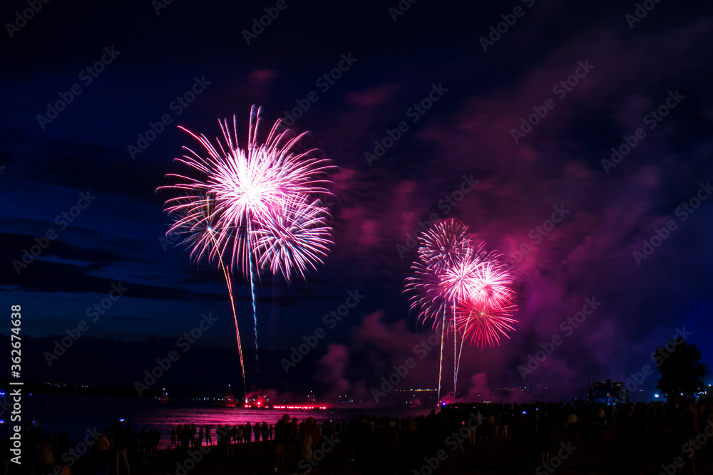 Celebratory fireworks in the night sky over the Volga river opposite the embankment in Samara city Celebratory fireworks in the night sky over the Volga river opposite the embankment in Samara city
