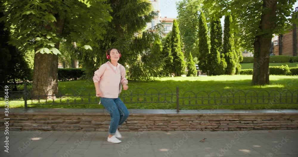 Happy asian student girl dancing outdoors in city street having fun laughing. Modern lifestyle. Happy asian student girl dancing outdoors in city street having fun laughing. Modern lifestyle.