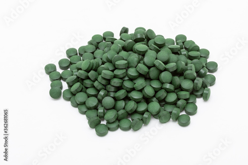 Spirulina seaweed tablets on white background