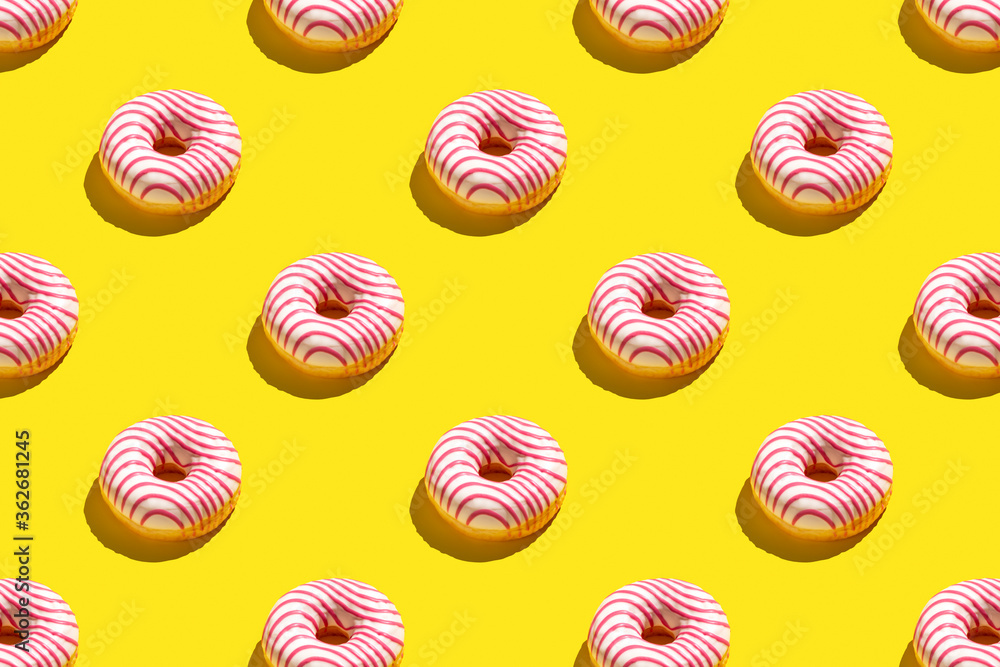 Flat lay pattern of tasty pink donut on yellow background. Flat lay pattern of tasty pink donut on yellow background.