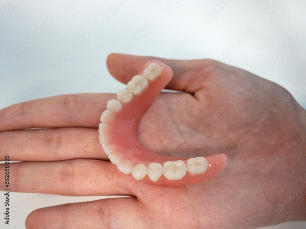 Dental technician at work - denture tooth Dental technician at work - denture tooth