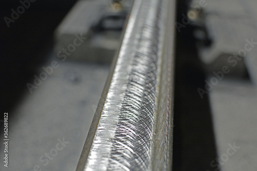 Railway track (in a subway) after rail grinding - close-up on the rails and the concrete sleepers - for restoring the profile and removing irregularities from a worn rail track