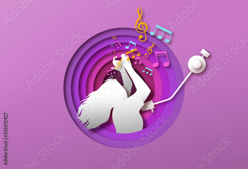 Woman dancing to music in papercut vinyl player