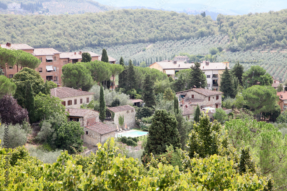 Beautiful scenery looking across Tuscany featuring vineyards, buildings, farms