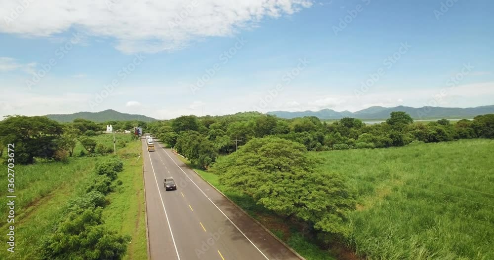 An aerial view of a two lane highway across many sugar cane and plantation fields in San Miguel, El Salvador An aerial view of a two lane highway across many sugar cane and plantation fields in San Miguel, El Salvador