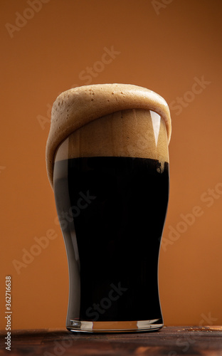 Canvas Print Overflowing stout in a shapely pint glass