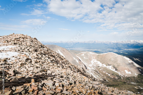 Landscape views of Colorado mountains from the summit of a peak. 