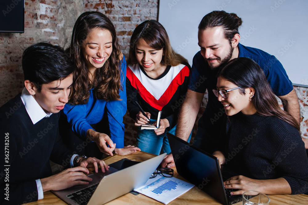 Successful hispanic teamwork or Group of latin young business people working together in creative office in Mexico or South America Successful hispanic teamwork or Group of latin young business people working together in creative office in Mexico or South America