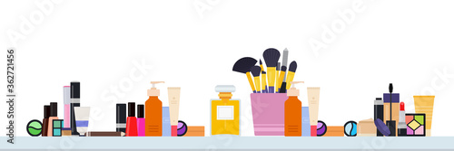 A table with a set of makeup and makeup tools vector illustration in a flat design.