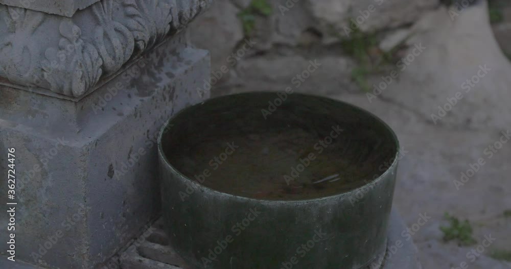 Dripping fountain. Close-up shot of a waterpot. Dripping fountain. Close-up shot of a waterpot.