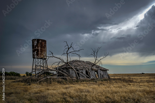 Abandoned farmstead structures on the Great Plains with Dramatic Skies Overhead