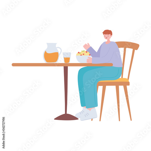 man in the restaurant eating and drinking alone because of social distancing restrictions, covid 19 pandemic