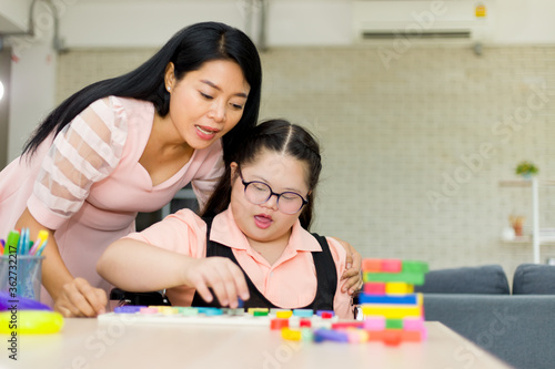 Autism girl with learning practice at home.