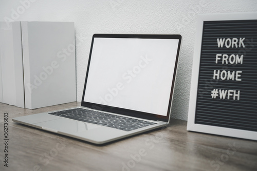 Minimalist laptop mockup white screen on white table with mouse. work from home concept