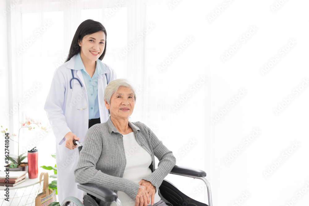 Asian health worker drive a wheelchair of old patient, doctor and old female talk about disease symptoms, happy hospital, rehabilitation activity, elderly healthcare promotion