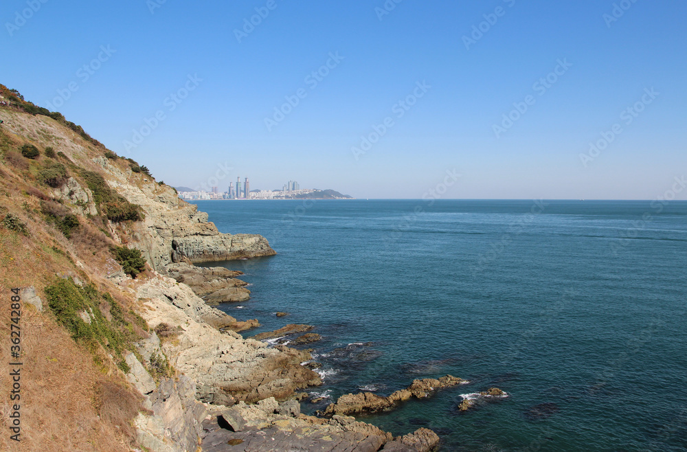 View of Igidae park coastline and Haeundae district from Oryukdo Skywalk in sunny day, Busan, South Korea