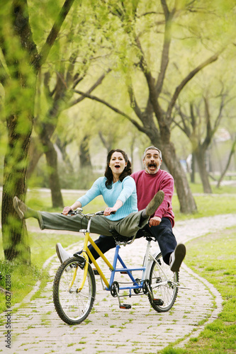 Couple having fun cycling in the park