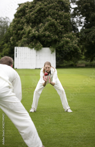 Man and woman playing cricket photo