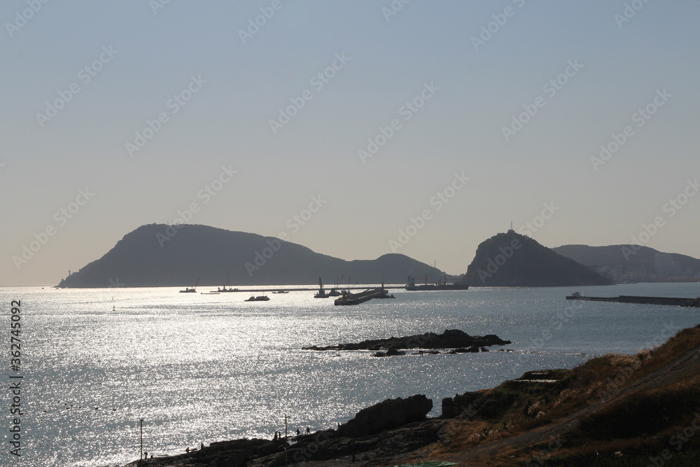 Seascape at Oryukdo Island with the ships and mountains in sunny day, South Korea