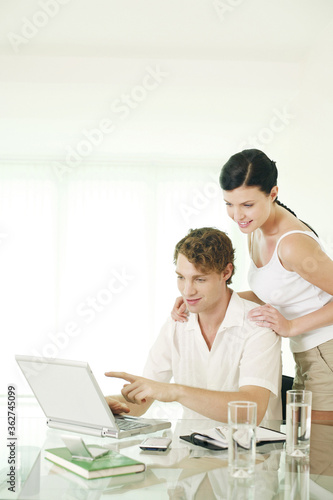 Couple using laptop © ImageHit