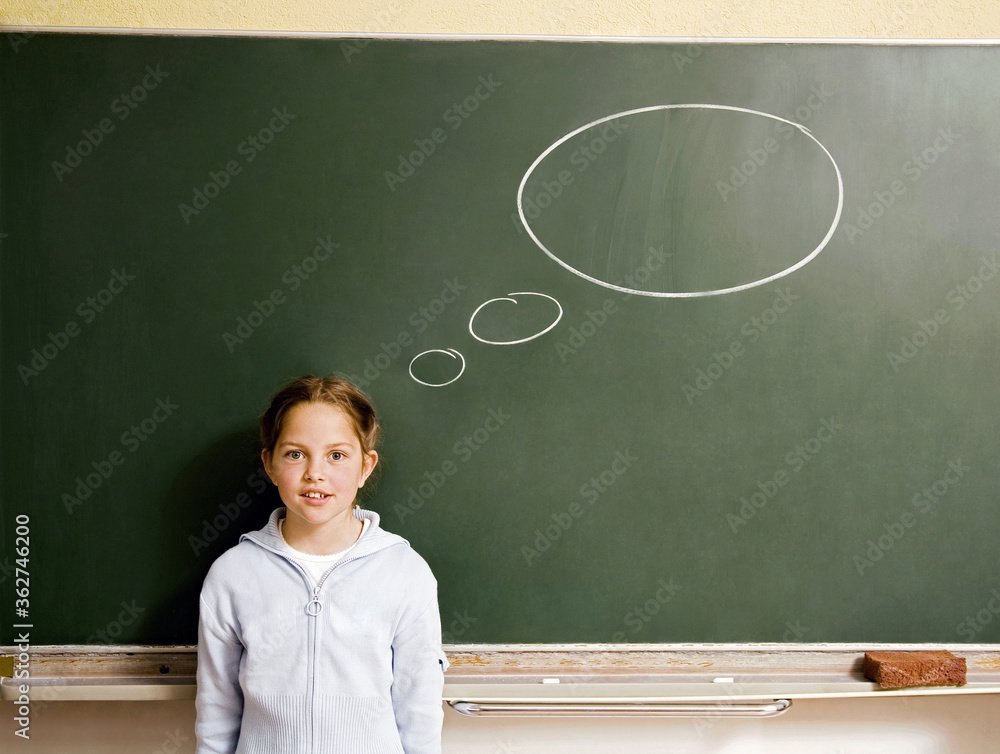 Girl standing in front of a blackboard with thought bubble