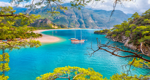Fototapeta Naklejka Na Ścianę i Meble -  Brown gulet anchored at the Aegean sea - Panoramic view of Oludeniz Beach And Blue Lagoon, Oludeniz beach is best beaches in Turkey - Fethiye, Turkey