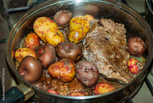 Beef steaks cooked to the pan with onions, Andean potatoes, fine herbs and spices. photo