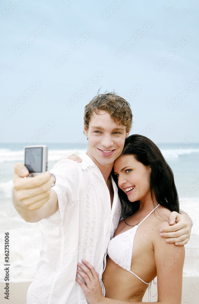 Couple taking picture on the beach