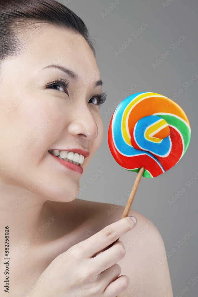 Woman with lollipop looking to the side