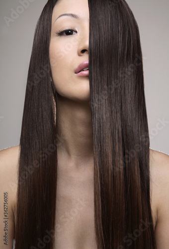 Young woman with long straight hair posing for the camera