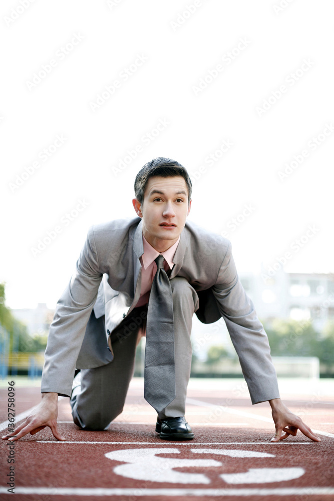 Businessman getting ready on the running track Businessman getting ready on the running track
