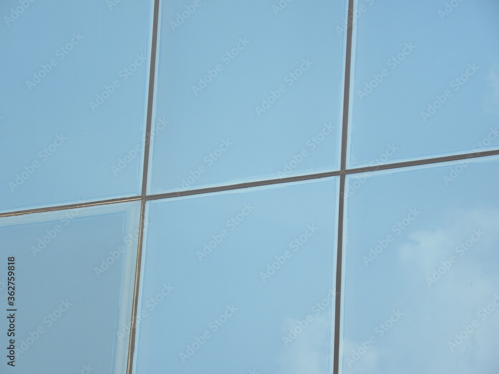 Fototapeta premium Blue color steel and glass wall of building textured background