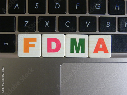 Abbreviation FDMA (Frequency Division Multiple Access) on keyboard background photo