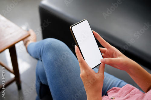 close-up women use smart phone mobile white screen on sofa