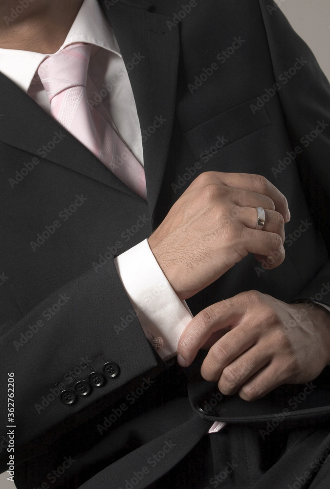 Businessman adjusting her sleeve