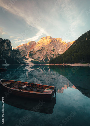 lake Braies (Lago di Braies) with sunlight on the mountain peak in Dolomites, Italy