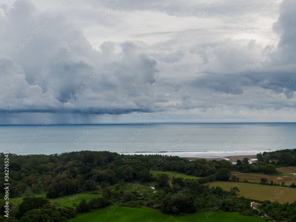 Fototapeta premium Beautiful aerial view of a Strong rain storm in the middle of the ocean, near the beach of Costa Rica